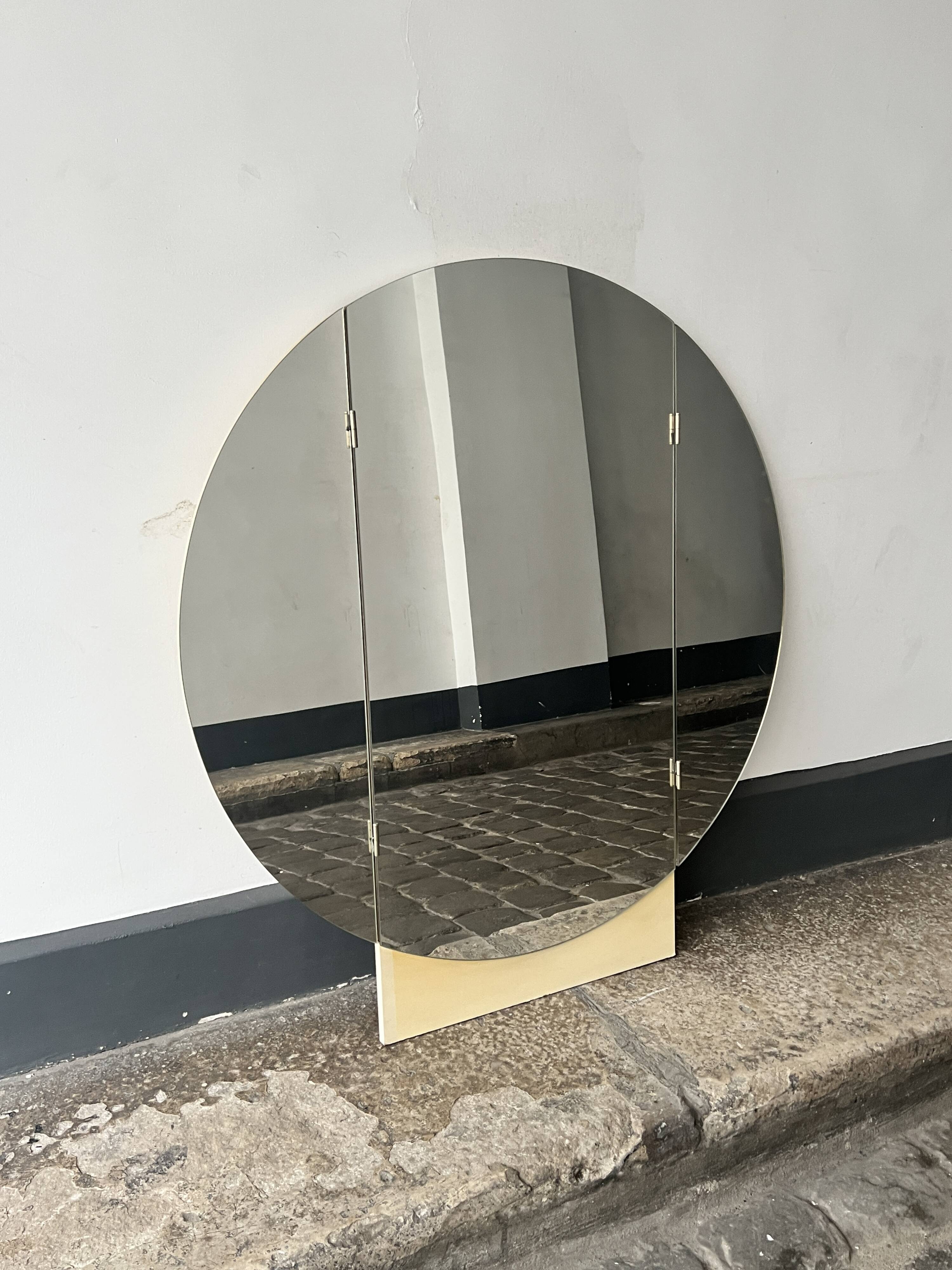 Large round triptych mirror with ivory background and back, 1970s design.