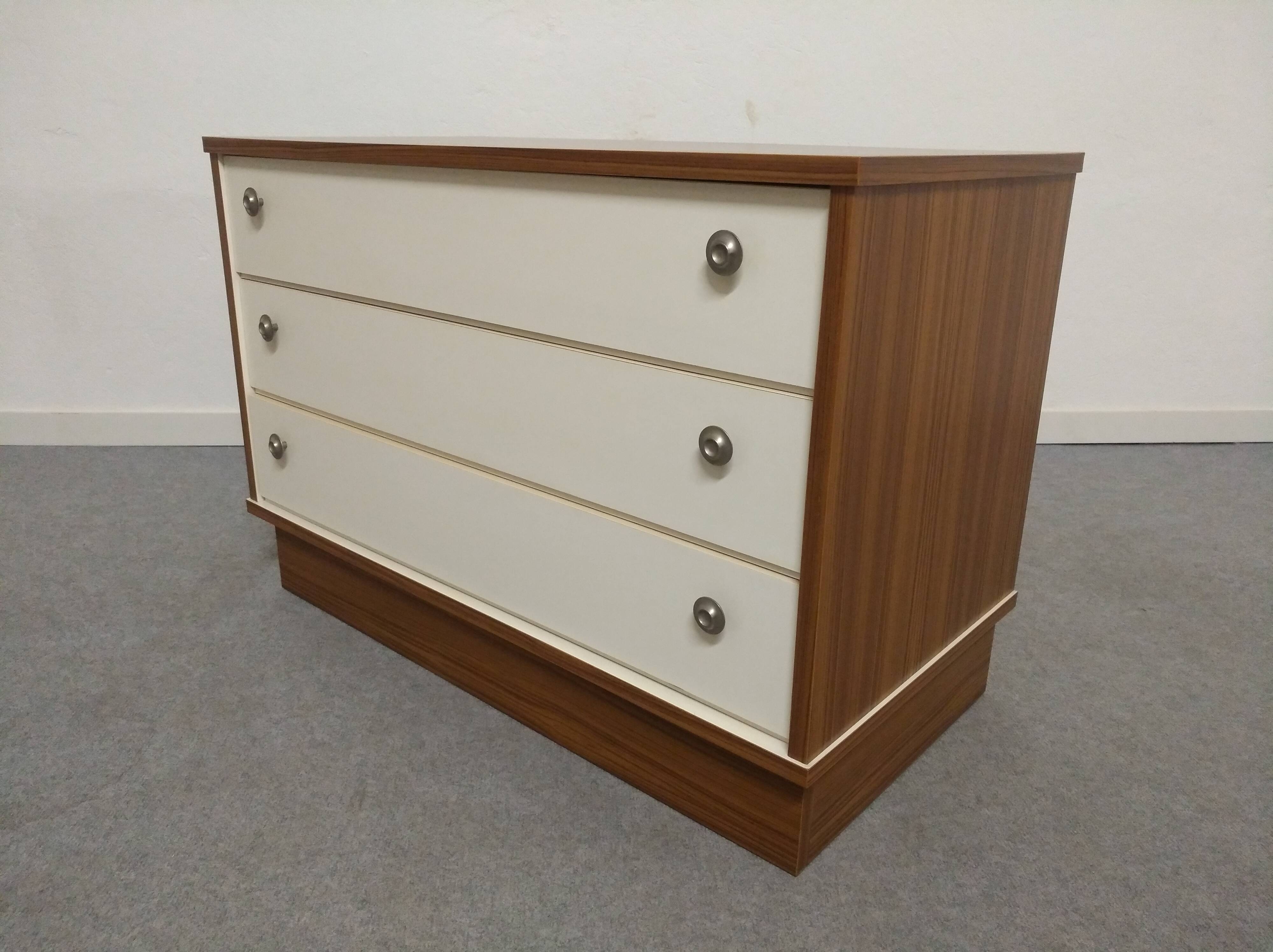Low chest of drawers with 3 drawers in mahogany and white satin, France circa 1980.