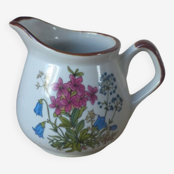 Old small artisanal milk jug in flowered speckled stoneware from the 1980s