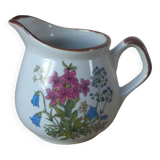 Old small artisanal milk jug in flowered speckled stoneware from the 1980s