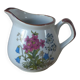 Vintage handmade speckled stoneware milk jug with floral design from the 1980s.