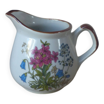 Old small artisanal milk jug in flowered speckled stoneware from the 1980s