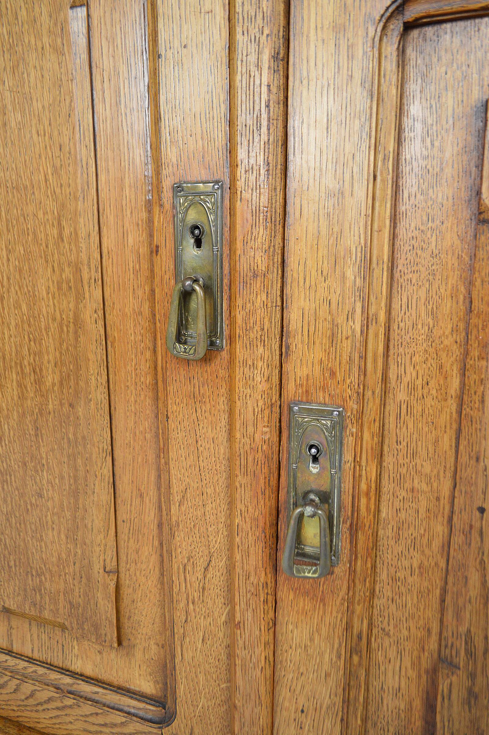 Art Nouveau oak buffet and dinanderie panels, circa 1910