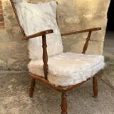 Scandinavian armchair in solid wood with beige fur cushion