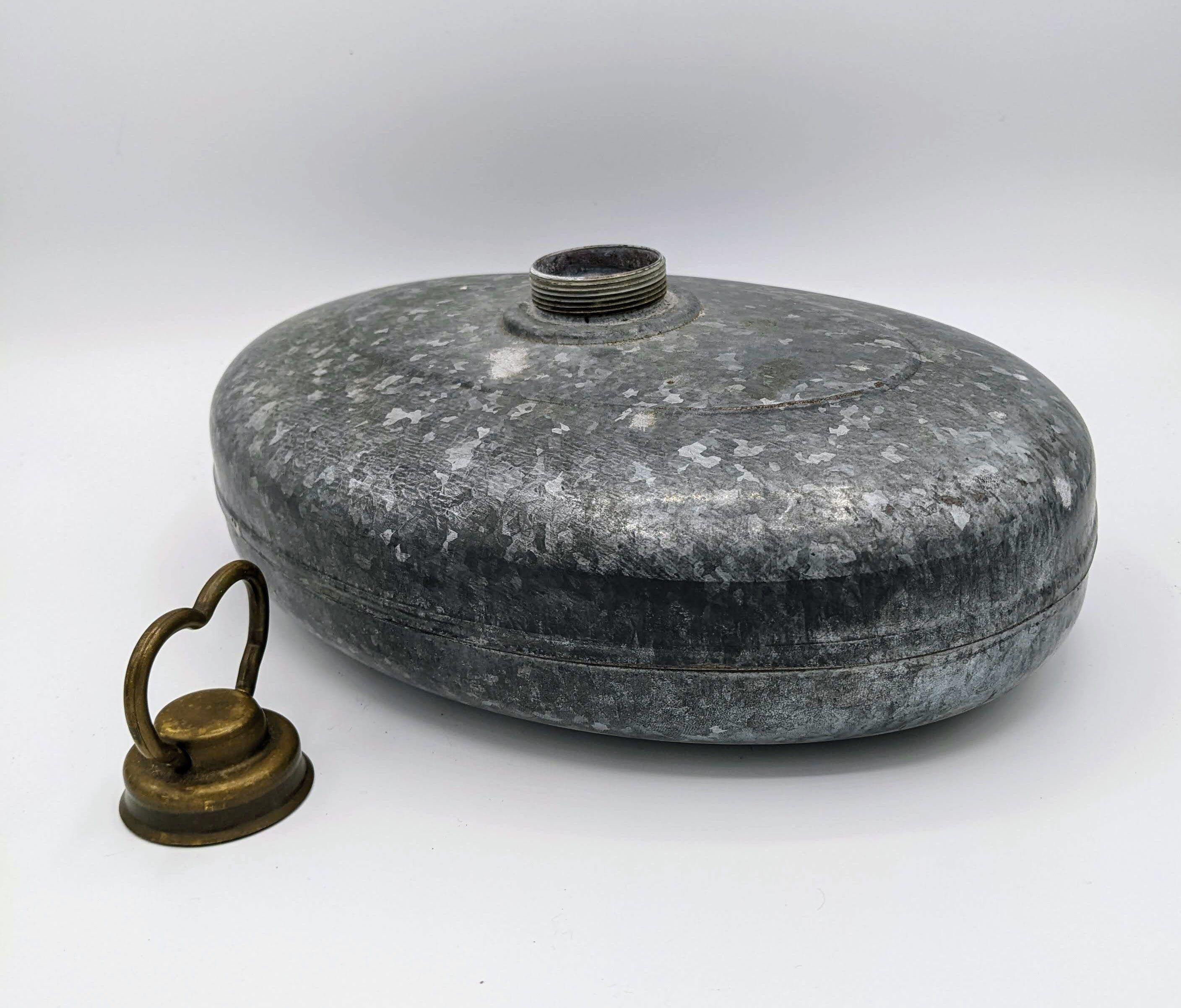 Old metal hot water bottle