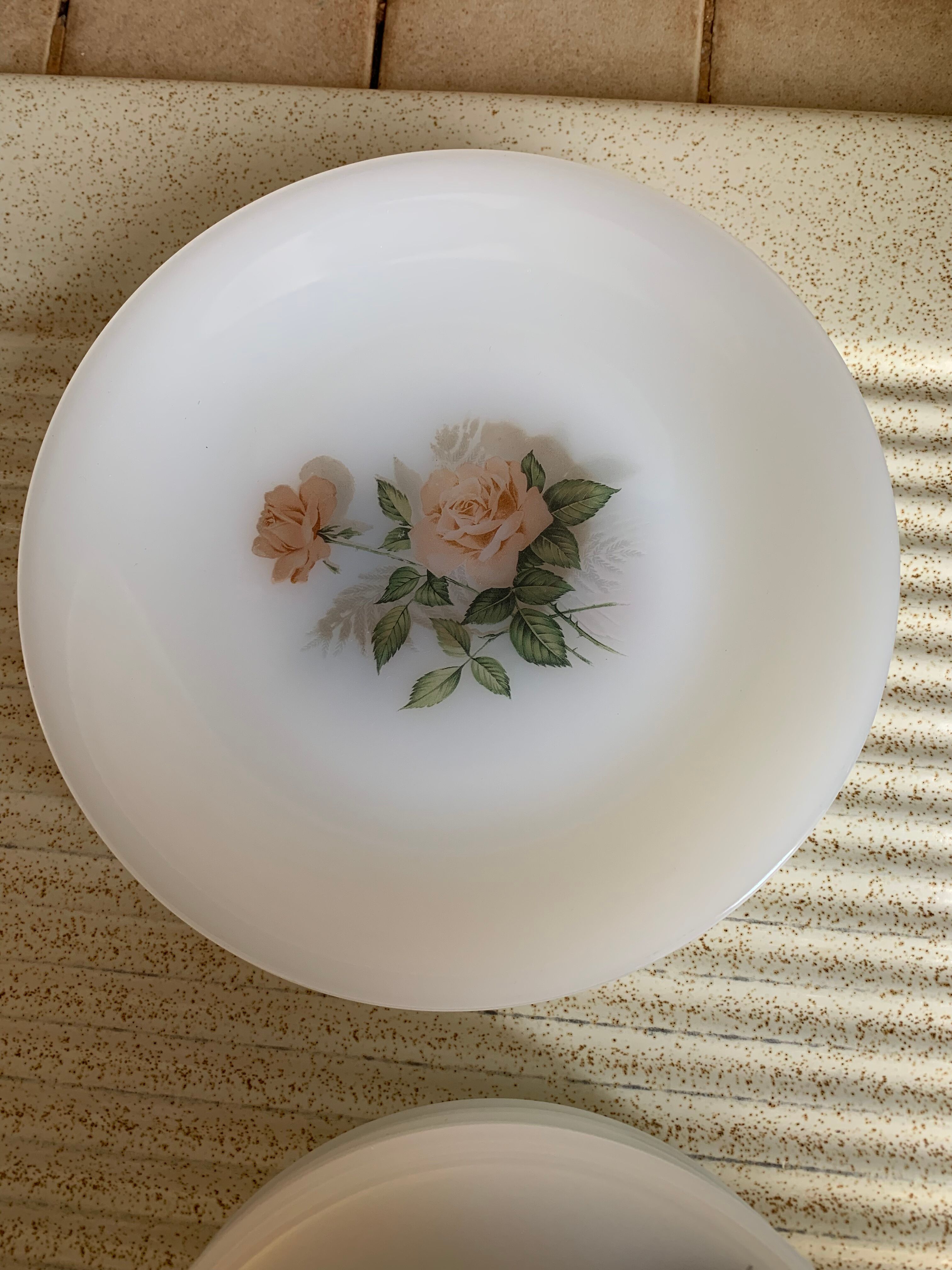 Lots of vintage plates in arcopal floral pattern