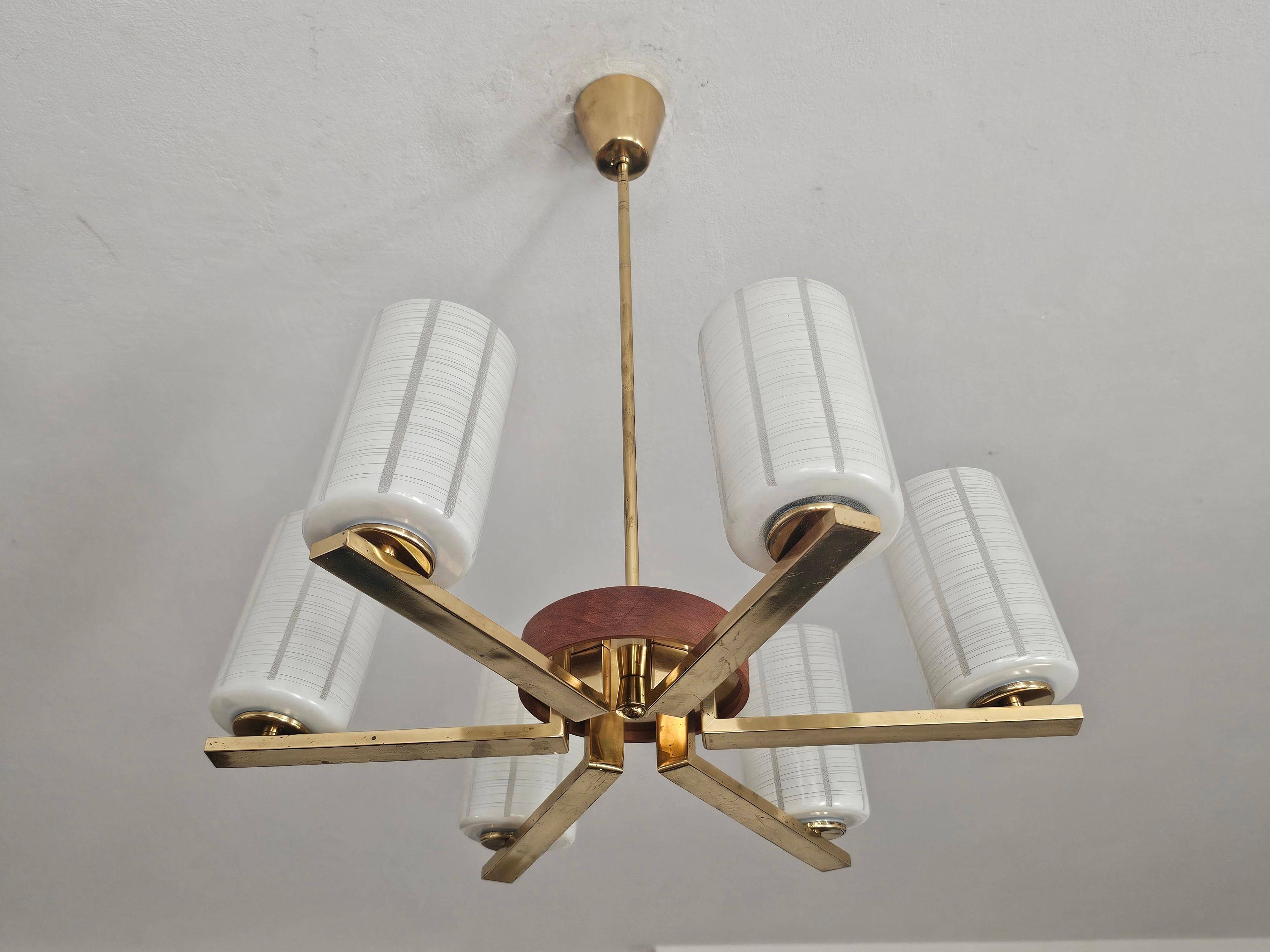 Lustre Mid Century Modern with 6 brass arms, teak, and frosted glass.