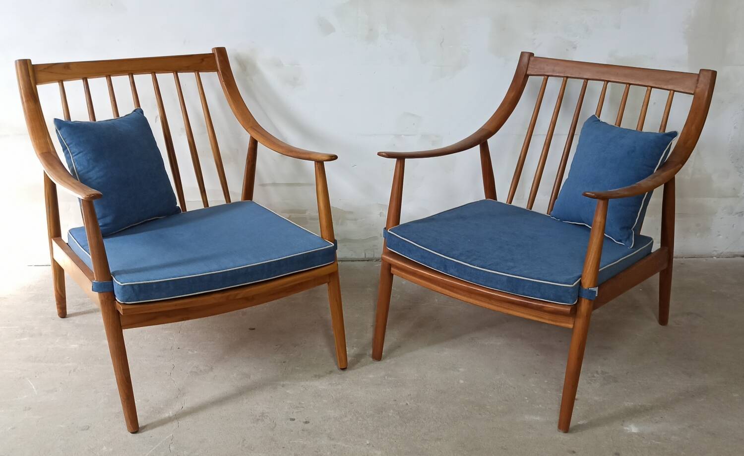 Pair of cozy teak armchairs with cushions