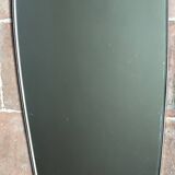 Vintage 1960 free-form mirror known as a retro mirror with a gold and black metal trim.
