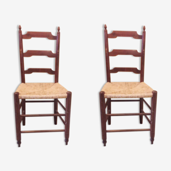 2 wooden and straw chairs