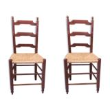 2 wooden and straw chairs