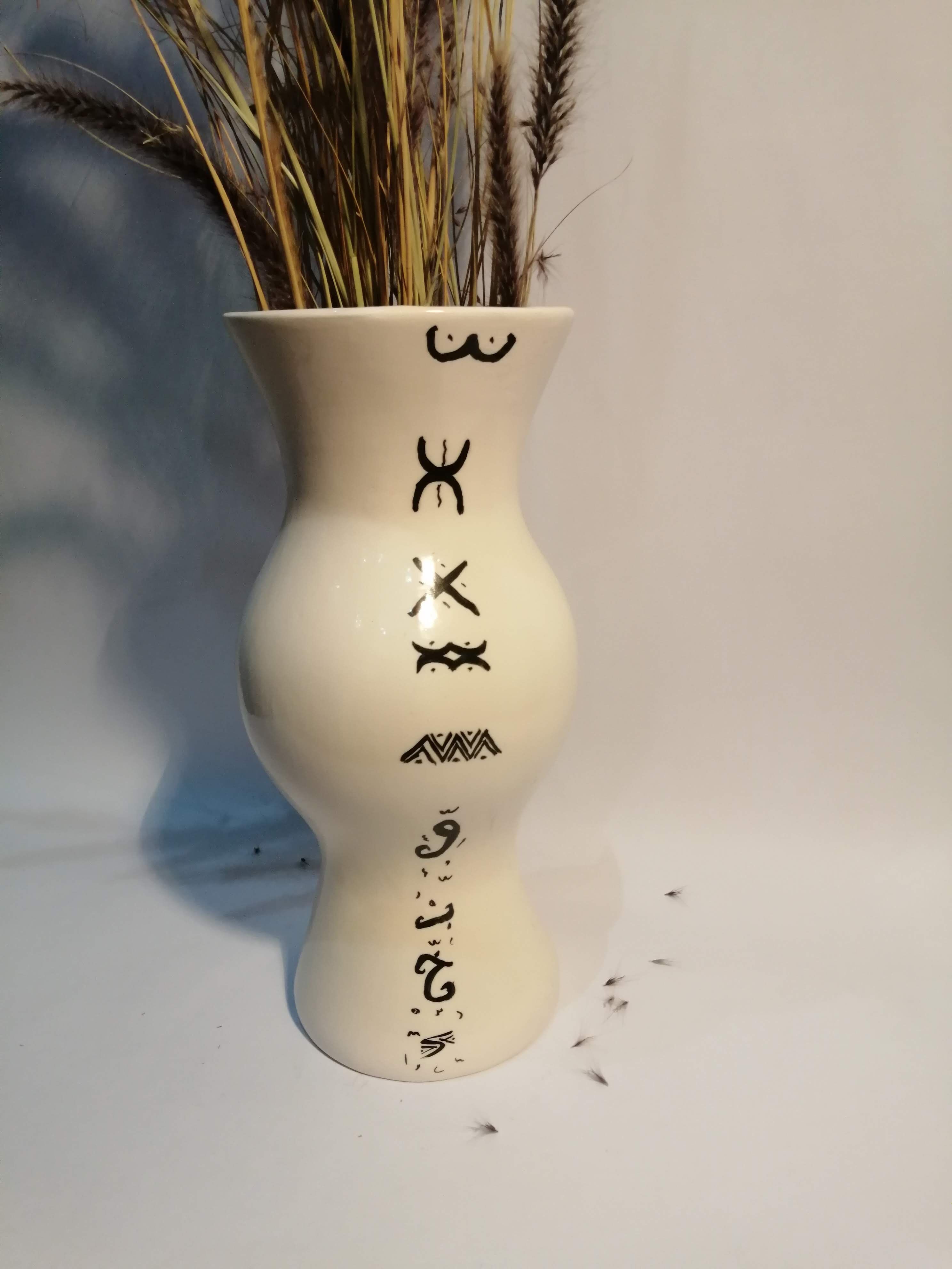 Vase is decorated in white clay;han mad