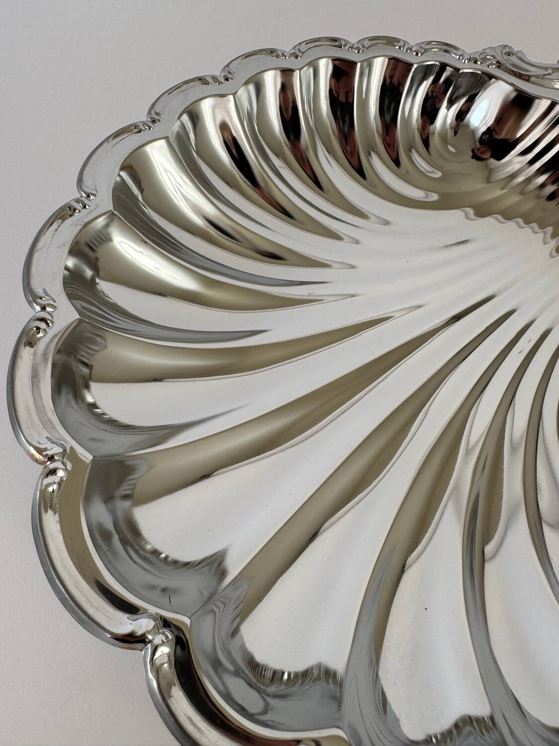 Large silver-plated serving dish in the shape of a vintage shell.