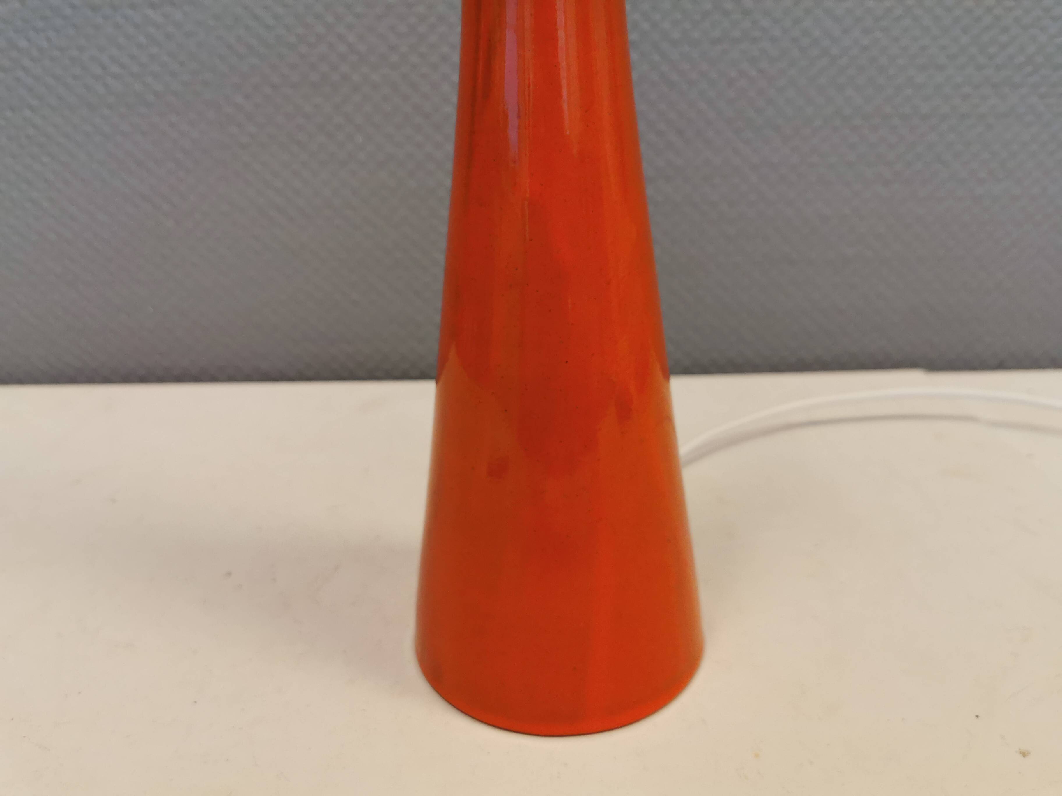 Ceramic table lamp with partial orange glaze.