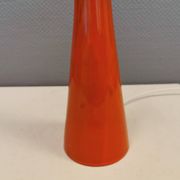 Ceramic table lamp with partial orange glaze.