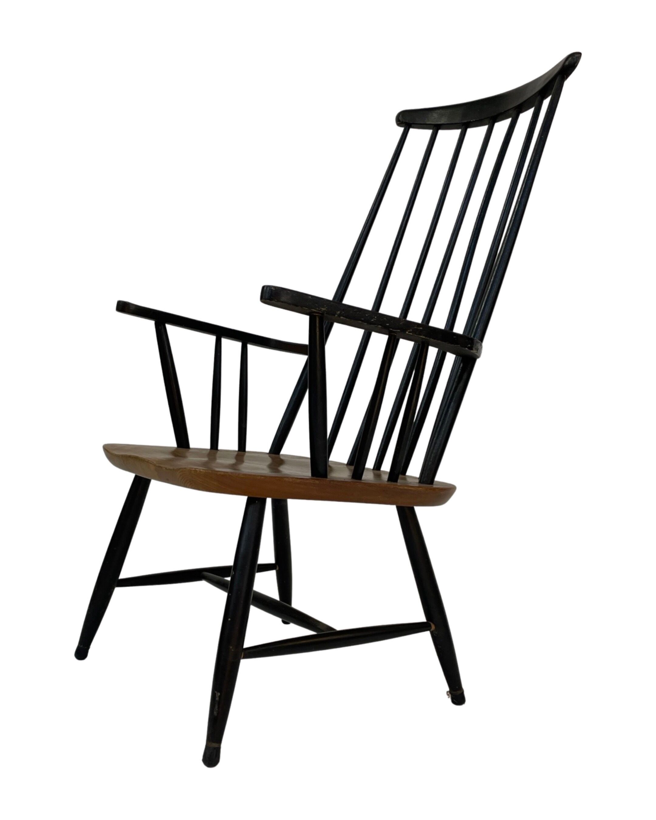 Vintage easy chair with high back and armrest from the 60s