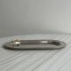 Small stainless steel tray with knot pattern.