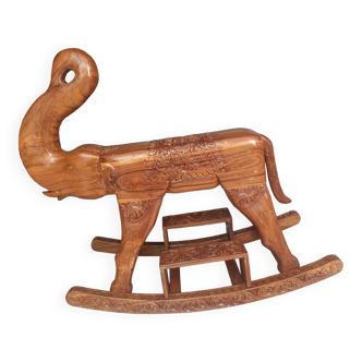 Decorative rocking elephant in carved exotic wood.