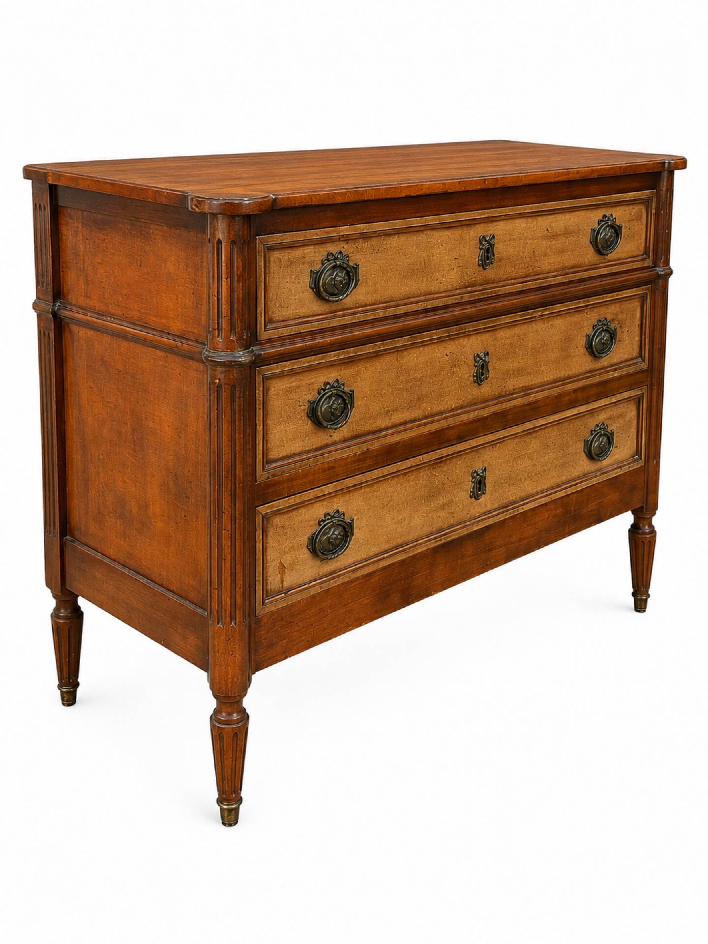 Light walnut commode in Louis XVI style with fluted motifs and three drawers.