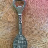 Bottle opener, opens bottle in golden brass shape of racket design and vintage