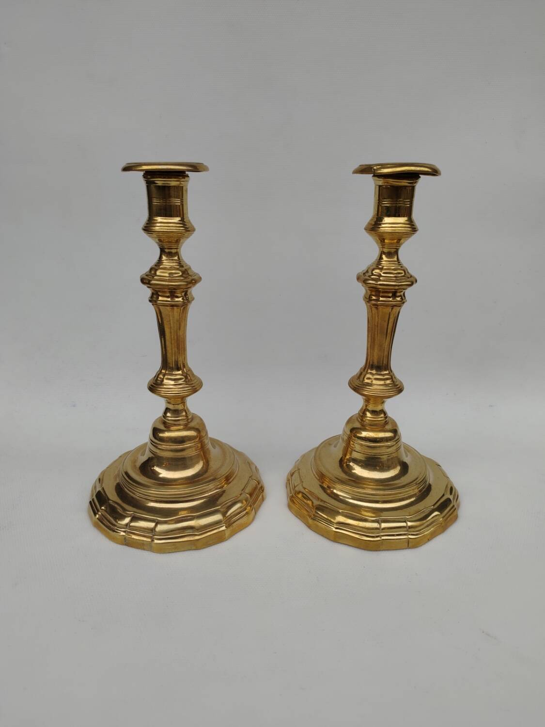 Pair of solid brass candlesticks, early 18th century.