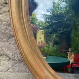 Golden oval mirror