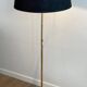 Brass floor lamp with a tripod base and claw feet from Maison Jansen.