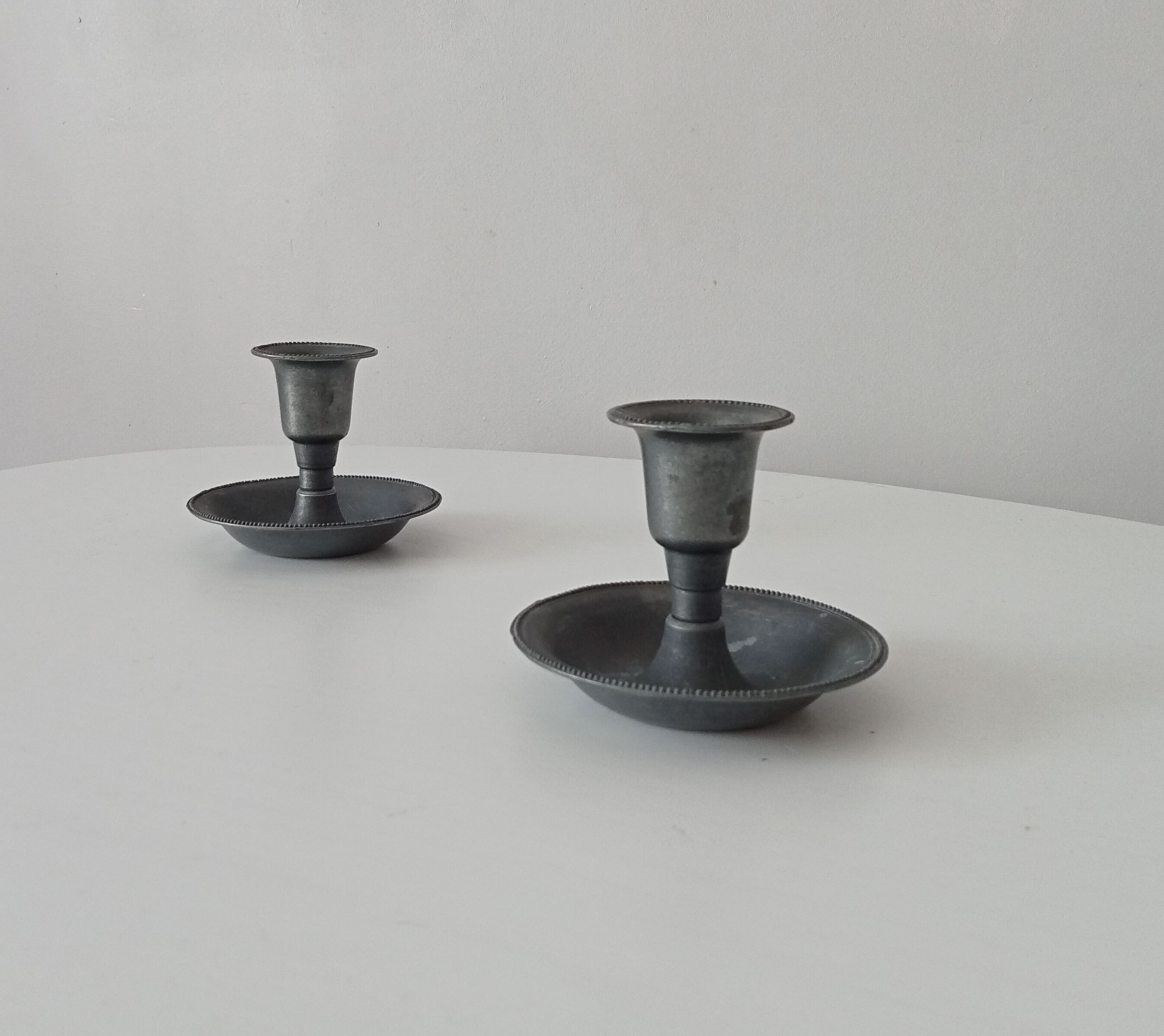 Pair of antique pewter candle holders