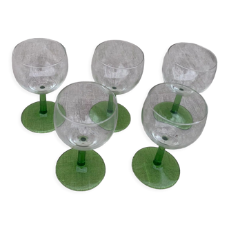 5 transparent glass glasses and green glass vase go
