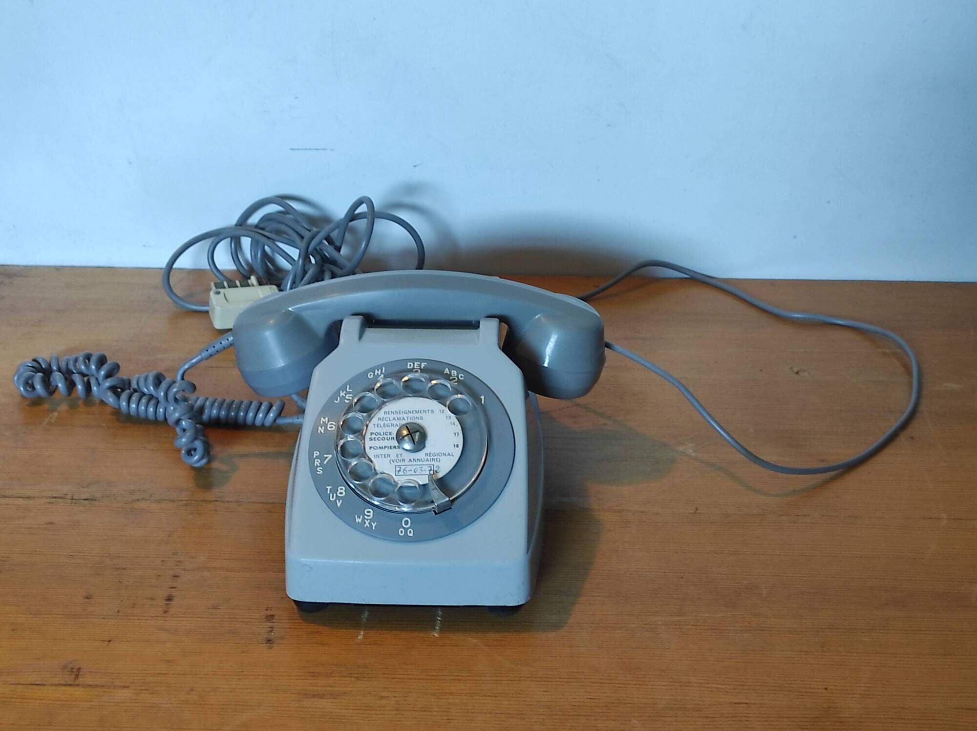 Old vintage wired dial phone with its earphone, gray color. Late 70s - early