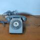 Old vintage wired dial phone with its earphone, gray color. Late 70s - early