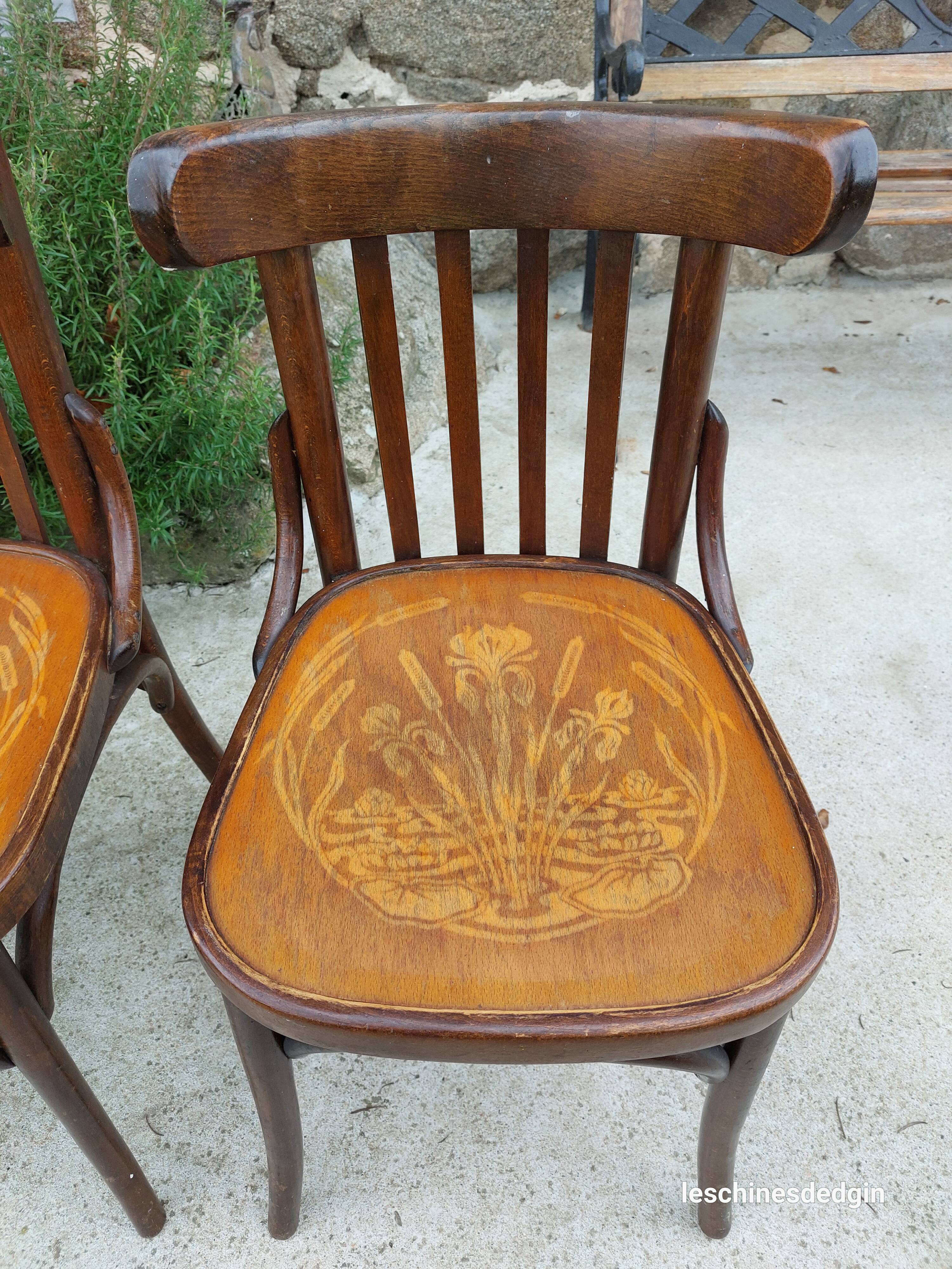 4 bentwood bistro chairs with a pattern on the seat