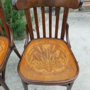 4 bentwood bistro chairs with a pattern on the seat