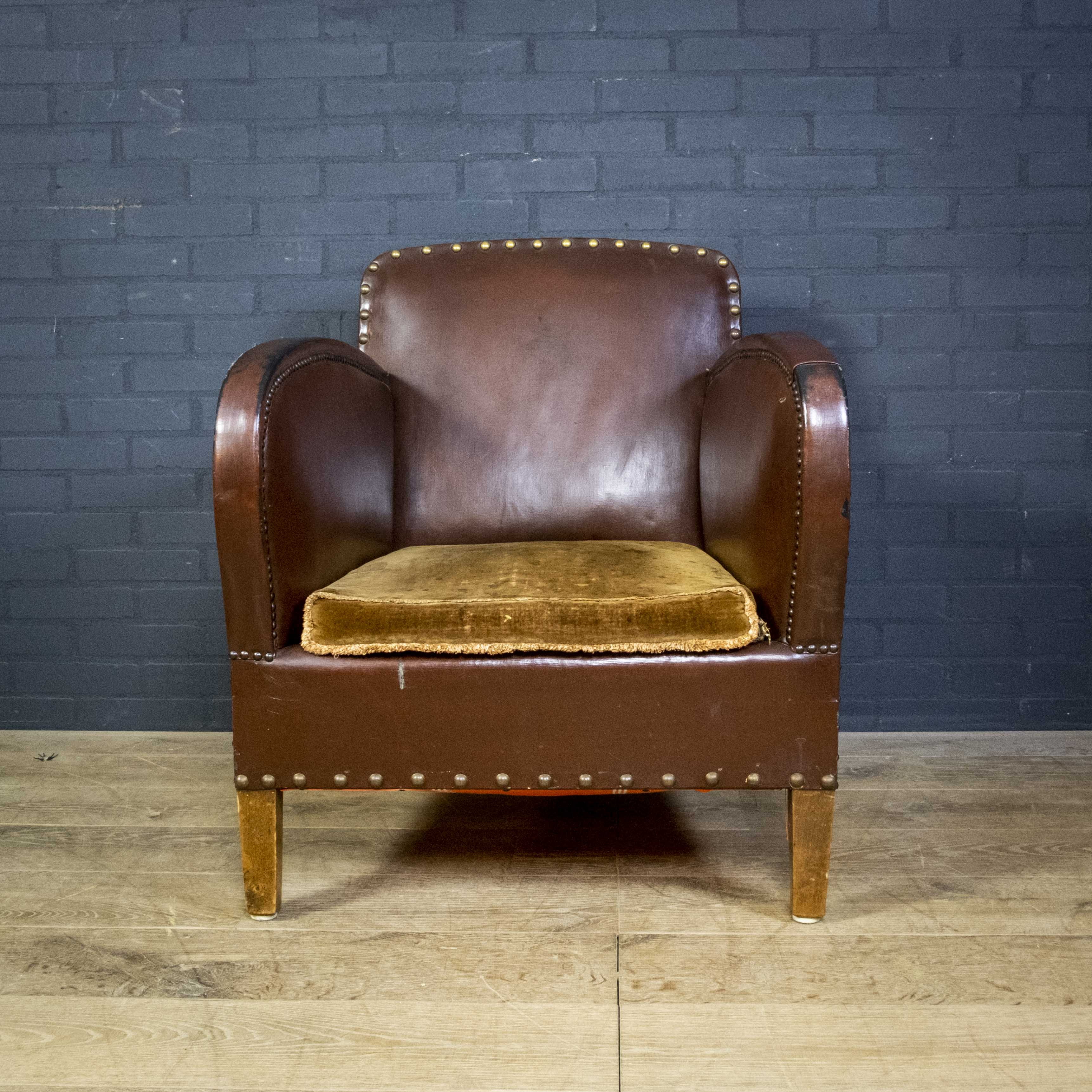 Antique club armchair of leather cloth
