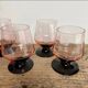 4 pink glasses with black stems