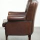 Subtle sheepskin wingback armchair with a deep cognac colour
