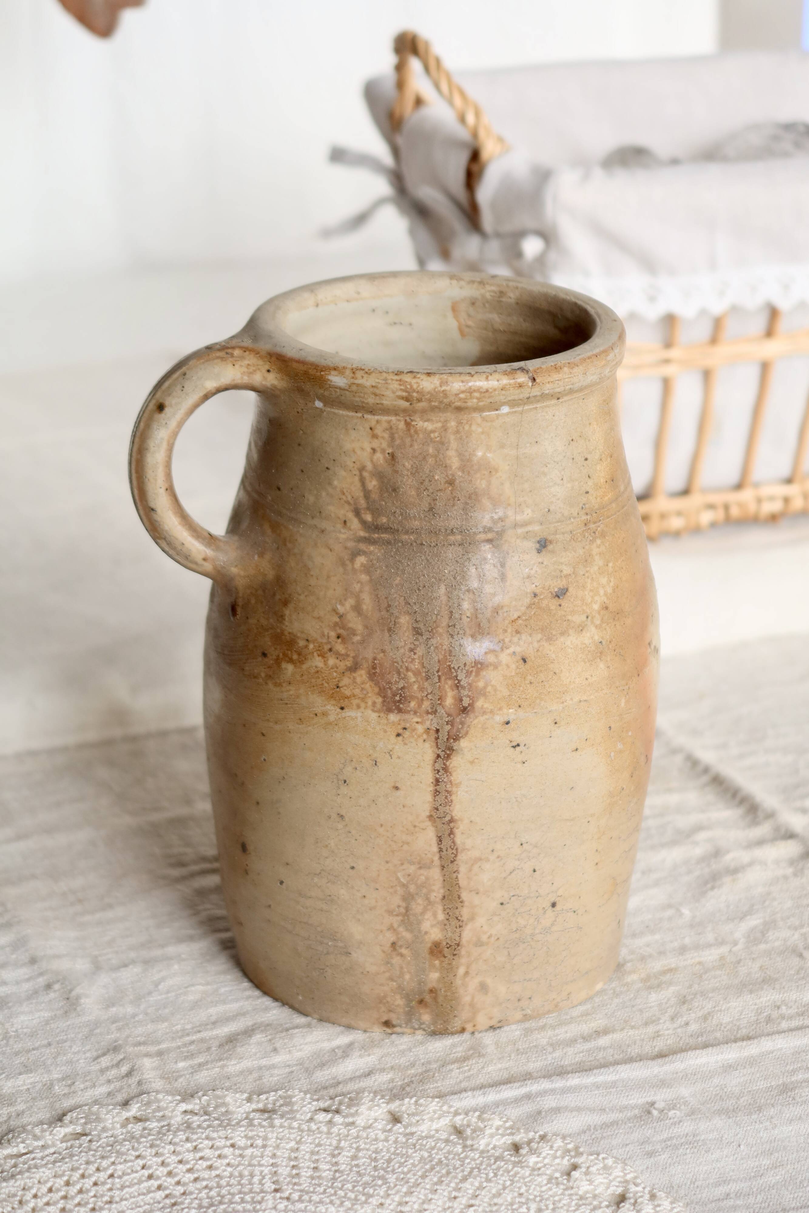 Old rustic stoneware jar with handle