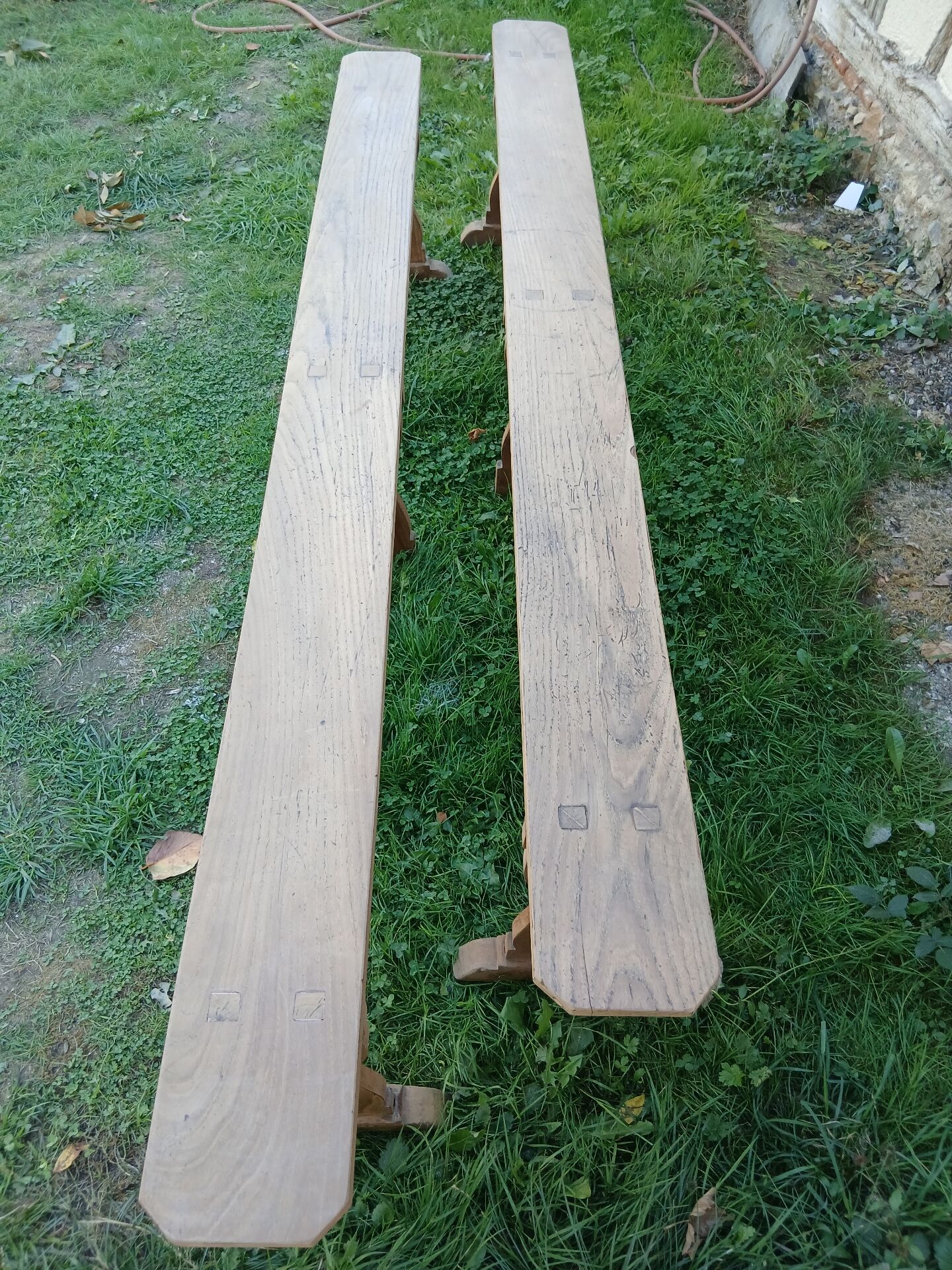 Pairs of large benches in raw fir wood.