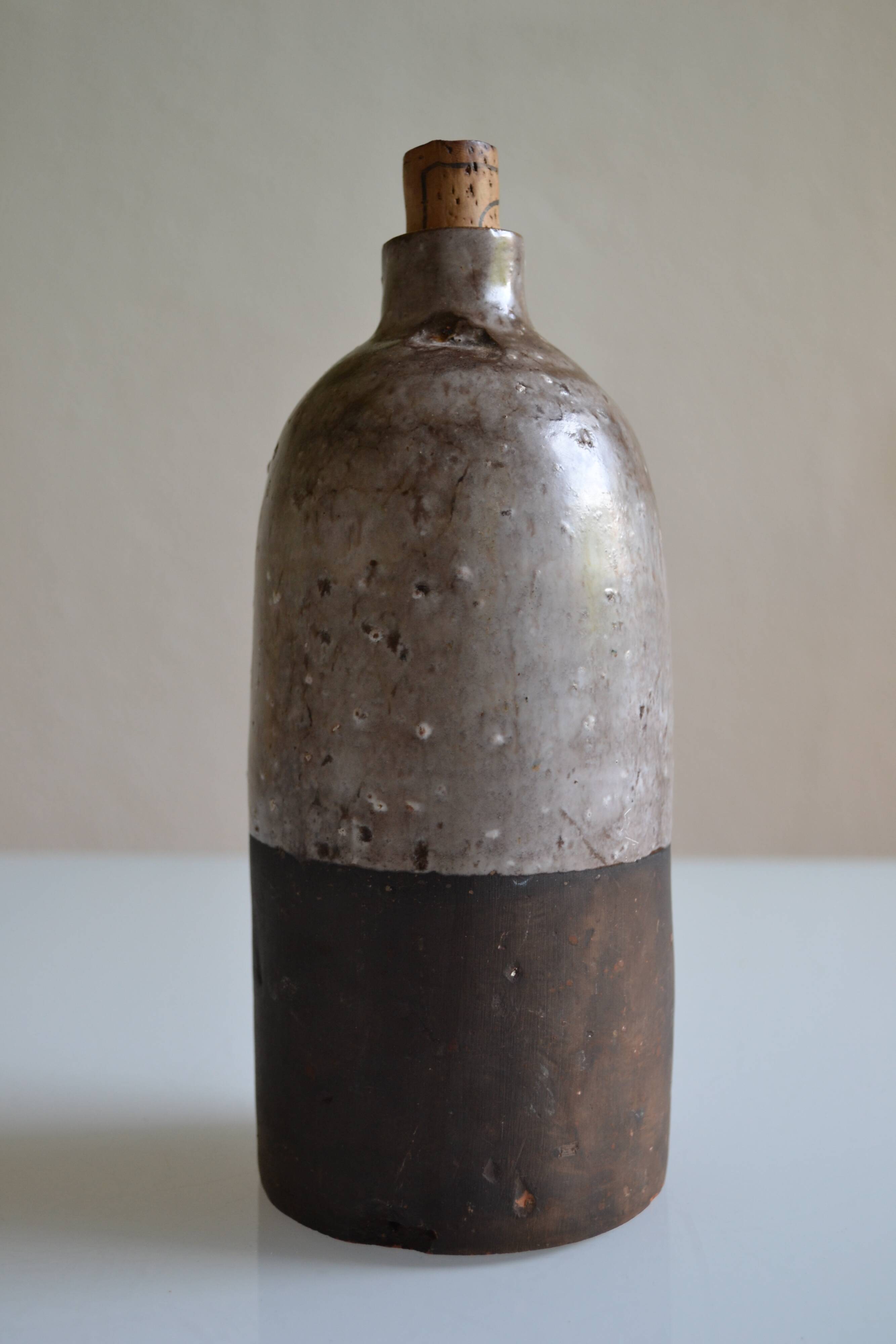 Ceramic bottle vase with a fish signature to be identified.