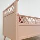 Vintage wooden baby bed in old pink
