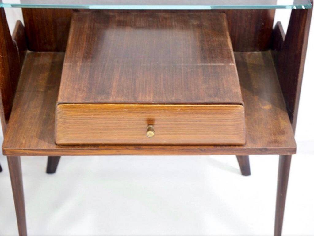 Pair of modernist Italian bedside tables in wood with a glass top.