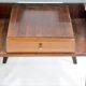 Pair of modernist Italian bedside tables in wood with a glass top.