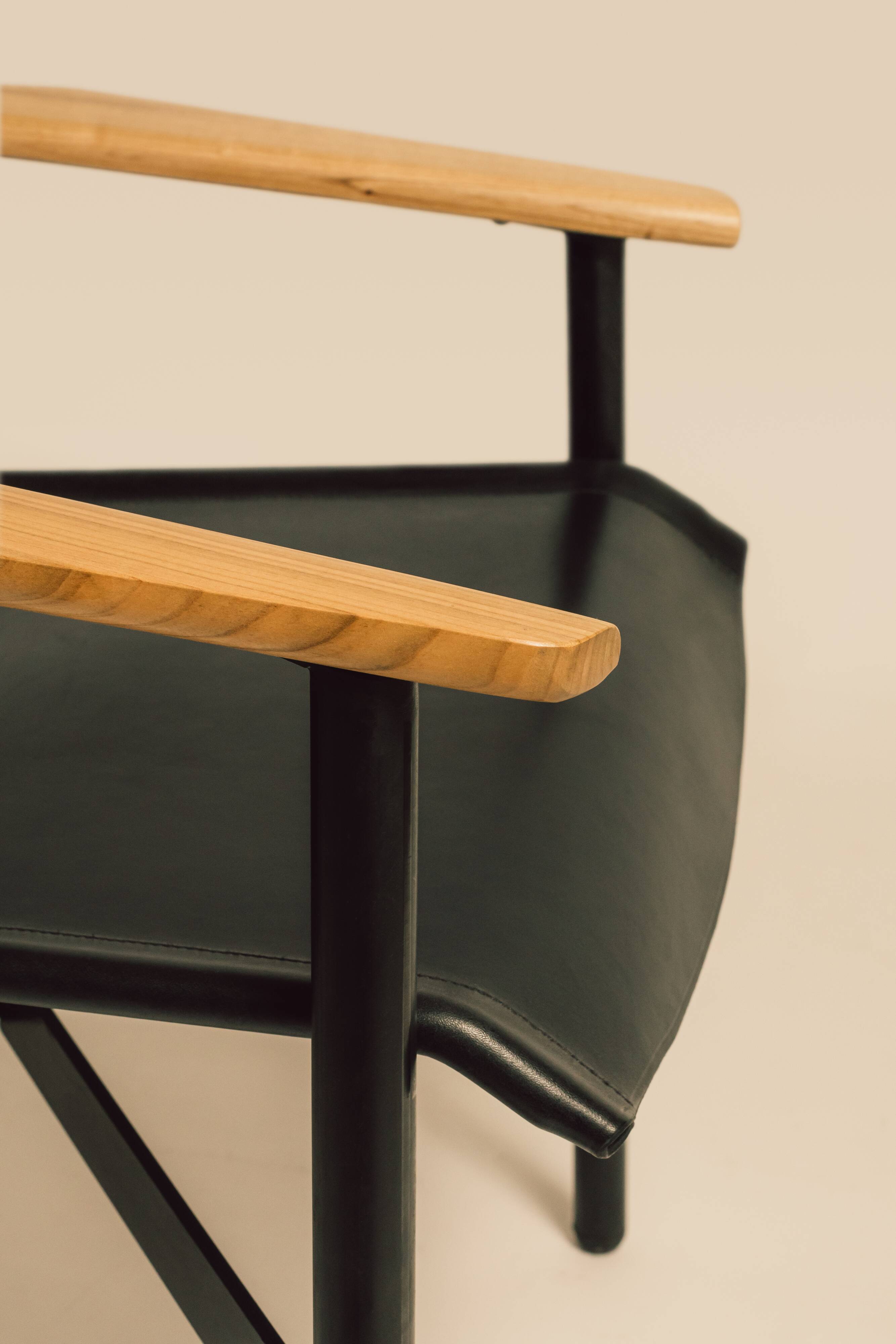 Maërl armchair, Galathée model, black leather, solid wood armrests of your choice