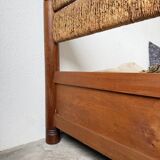 Brutalist style bed with chain and straw