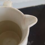 Old earthenware pourer with blue edging decoration