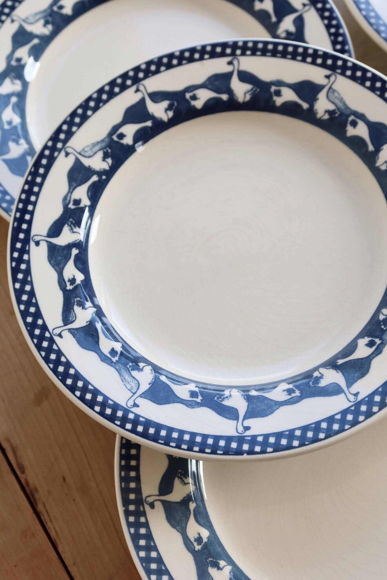6 vintage flat plates with a blue and white goose pattern.