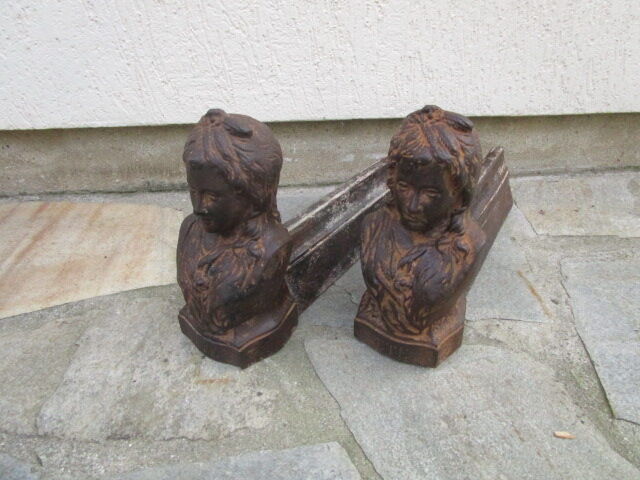 Pair of antique women's head cast iron chenets