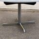 White dining table with a central pedestal, extendable, from the 1970s.