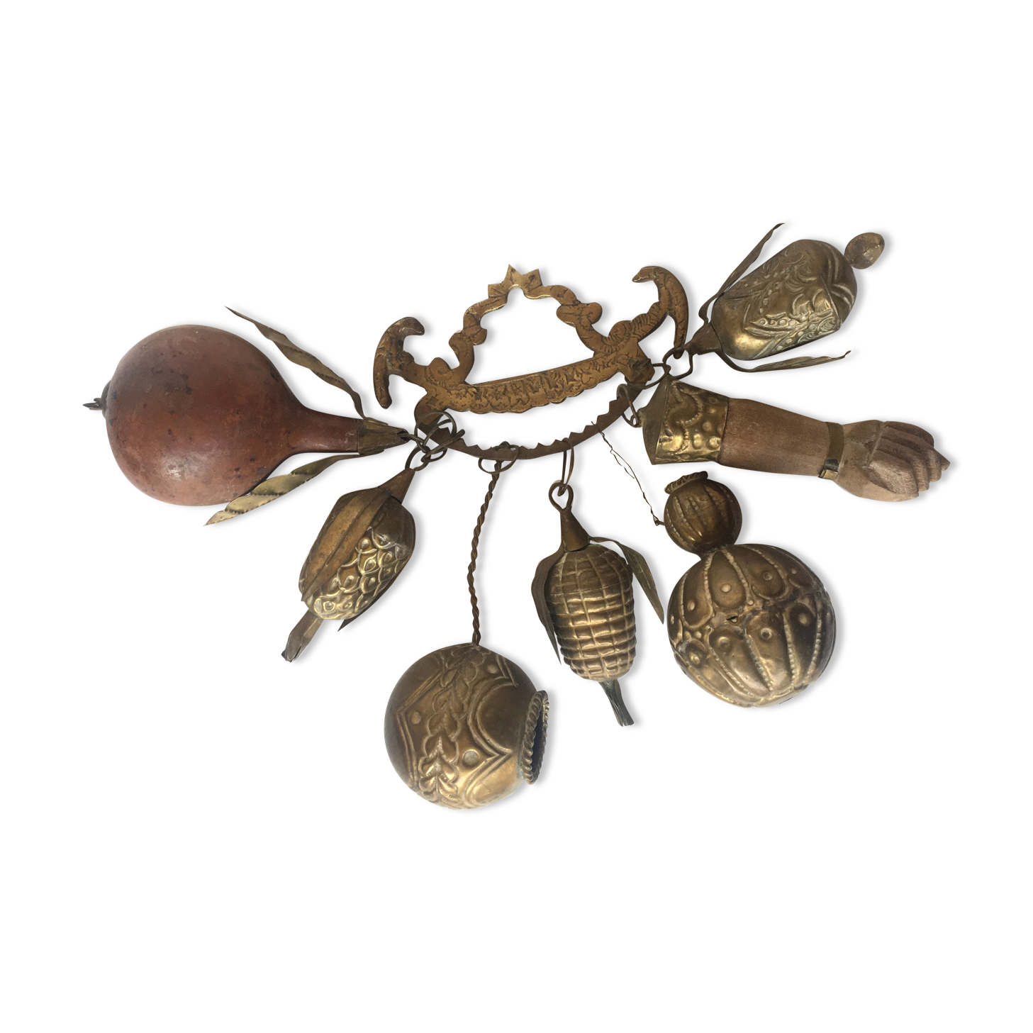 Wall decoration of brass and wood amulets