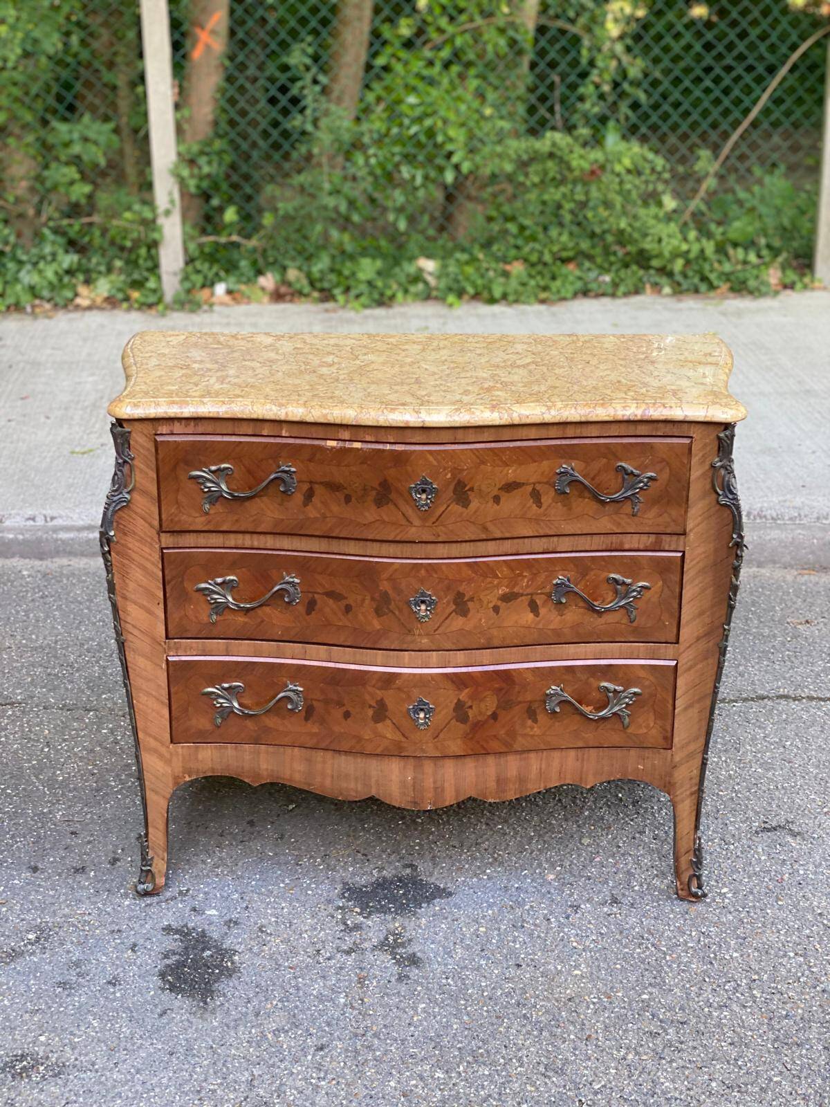 Curved Louis XV chest of drawers in marquetry and beige marble
